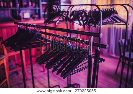 Stock Of Empty Clothes Hanger In Wardrobe, Wooden Coat Hangers Hanging On A Cloth Rail Rack In Close