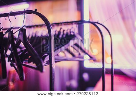 Stock Of Empty Clothes Hanger In Wardrobe, Wooden Coat Hangers Hanging On A Cloth Rail Rack In Close