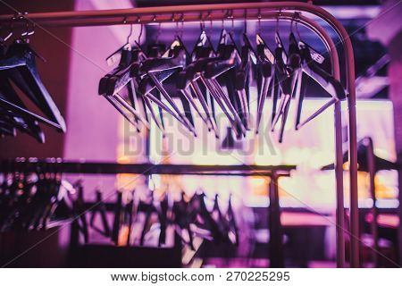 Stock Of Empty Clothes Hanger In Wardrobe, Wooden Coat Hangers Hanging On A Cloth Rail Rack In Close