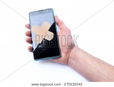 Smartphone With Cracked Display In Hand And Adhesive Bandage. Concept Of Repair Phones. Isolated On 