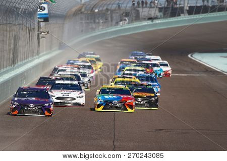 November 18, 2018 - Homestead, Florida, USA: Denny Hamlin (11) and Kyle Busch (18) lead the field down the front stretch during the Ford 400 at Homestead-Miami Speedway in Homestead, Florida.