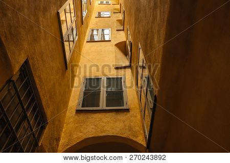Wall With Windows Of An Orange Building In Old Part Of A European Town. Building In The Center Of St