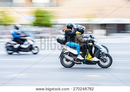 Motorcycle Rider With Pillion In City Traffic