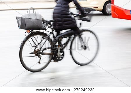 Bicycle Rider In City Traffic In Motion Blur
