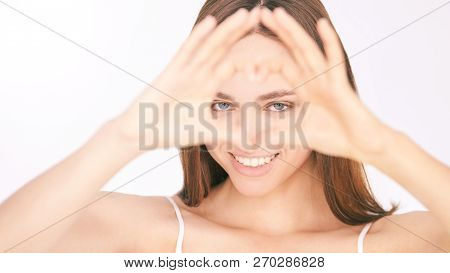 Eye Health Care. Young Beautiful Woman. Love Gesture