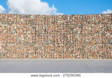 Decorative Wall From Rocks And Metal Wires.