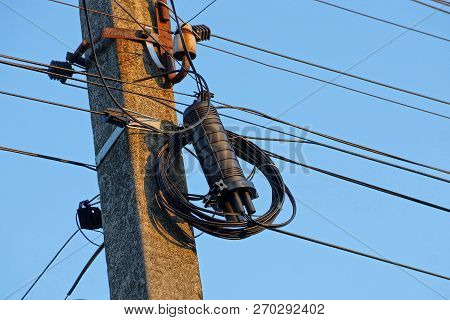 Electrical Wires And Black Box On A Gray Concrete Pillar