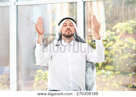 Muslim Man With Misbaha Praying Near Windows Indoors