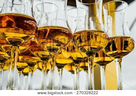 Dear Scotch Whiskey In Branded Glasses On A High Leg.