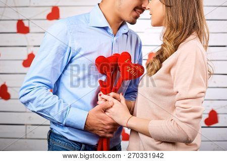 Young Happy Couple With Heart In Hands Onbackground