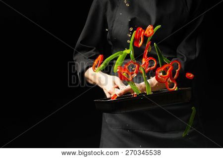 Cooking Fresh Vegetables In The Pan Chef. Horizontal Photo Viewing. Dark Black Background With Copy