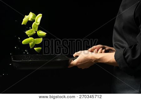 The Chef Cooks Green Tomatoes On The Pan. Black Background, Menu Or Recipe Book