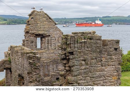 Ruin Incholm Abbey At Inchcolm Island With Freighter And Tugboats