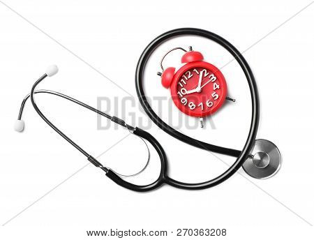 Stethoscope And Red Alarm Clock For Checking Pulse On White Background, Top View