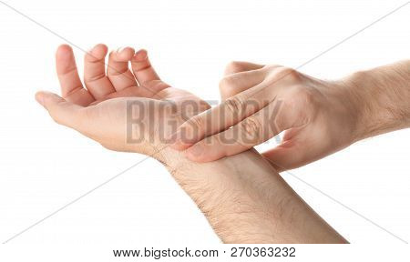 Man Checking Pulse On Wrist Against White Background, Closeup