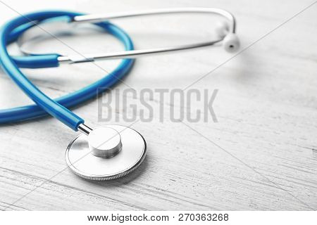 Stethoscope For Checking Pulse And Space For Text On Light Background, Closeup