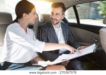Business Partners Working With Documents In Car, Preraring For Meeting