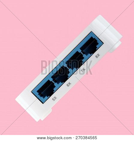 White 8 Port Plastic Ethernet Switch Isolated On Pink Background At Dry Day
