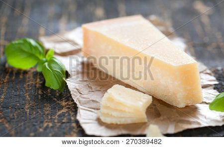 Pieces Of Parmigiano Reggiano Or Parmesan Cheese On Wood Board.