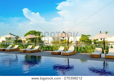 Ajman, United Arab Emirates - 30 October 2018: Pool Area With Sunbeds And Umbrellas In A Luxury Hote