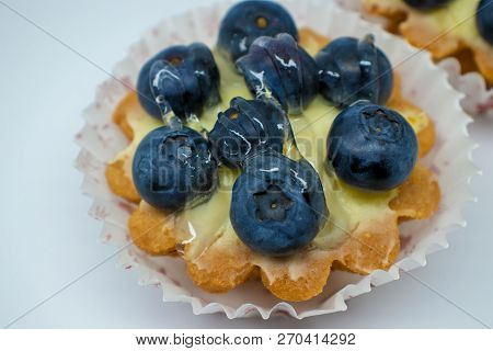 Tartlets With Blueberries Isolated On A Light Background.