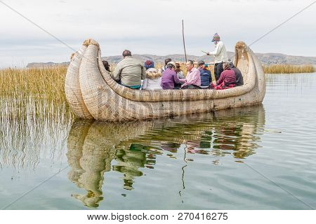 Titicaca, Peru - May 15, 2015: Visitors On A Reed Boat Near Uros Floating Islands, Titicaca Lake, Pe