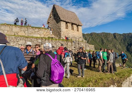 Machu Picchu, Peru - May 18, 2015: Tourists And A Building Called Guardhouse At Machu Picchu Ruins, 