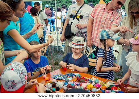 Zaporozhia/ukraine- June 2, 2018: Charity Family Festival-young Woman - Volunteer Explaining To Girl