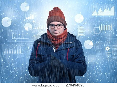 Young businessman shivering with graphs, reports and chart concept