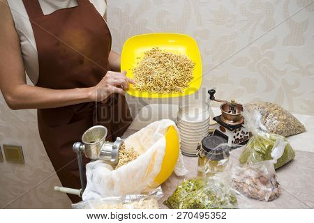 Young Beautiful Woman In An Apron Making Cake With Cream And Berries At The Kitchen