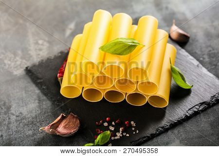 Fresh Raw Homemade Connelloni Pasta On Dark Table.