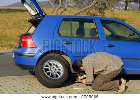 Man Changing A Tire