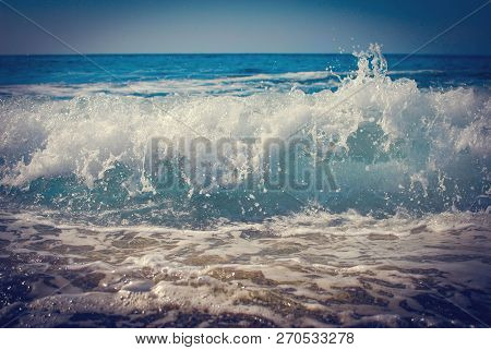 A Small Wave Going Ashore With Foam