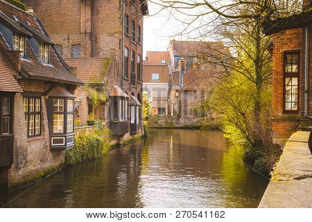 Scenic View Of The Historic City Center Of Brugge In Beautiful Golden Morning Light At Sunrise, Prov