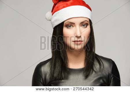 Young Girl In Santa Hat. New Year Beauty Portrait. Xmas People