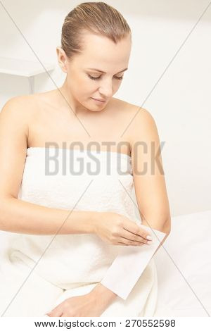 Unwanted Hair Wax Epilation. Young Woman. Cosmetology Salon Treatment Procedure. Home Waxing