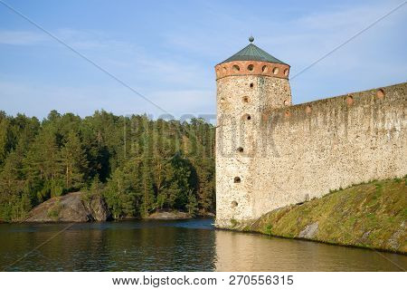 The Tower Of The Medieval Fortress Olavinlinna Close Up Against The Backdrop Of The Coast. Savonlinn
