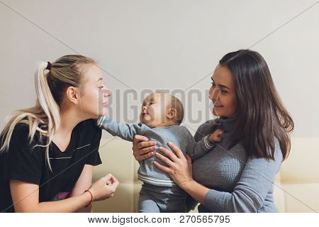 Happy Multi-ethnic Female Couple With Their Adorable Baby Boy.