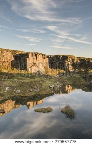 Beautiful Landscape Sunset Image Over Abandoned Foggintor Quarry In Dartmoor With Raking Soft Sunlig
