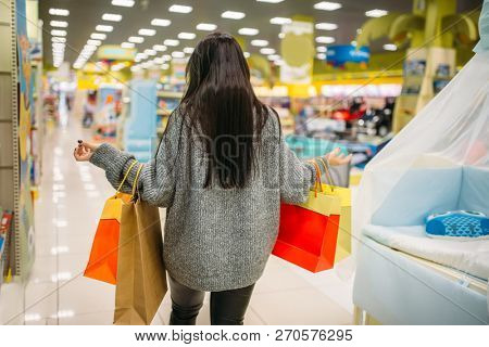 Woman shopping in the store for pregnant women