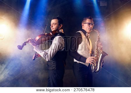 Saxophonist and violinist playing classical music