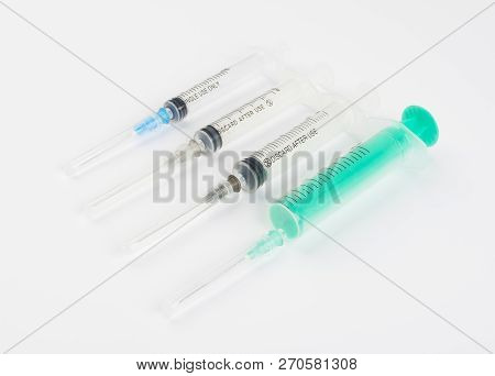 A Set Of Disposable Syringes For Injections Of Different Sizes On A White Background.