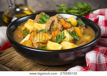 Goulash With Meat And Vegetables In Black Bowl. Beef Stew With Vegetables. European Cuisine.