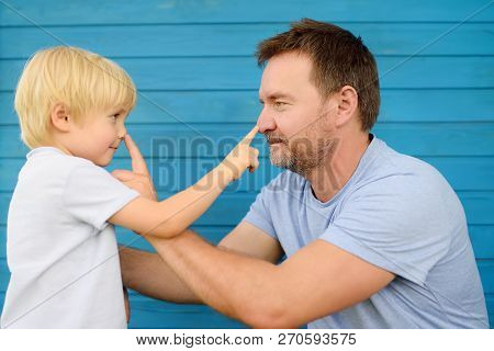 Cute Little Boy And His Father Pressed Finger On Each Other's Nose