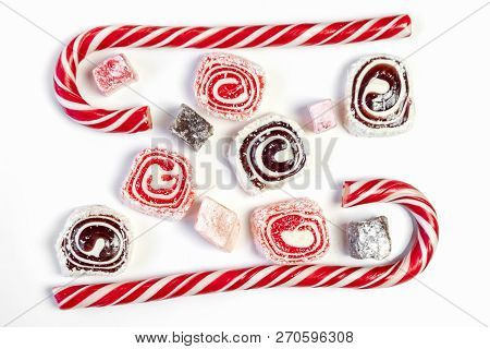 Sweet Candy Background. Red And Maroon Candies On White Background. Top View.