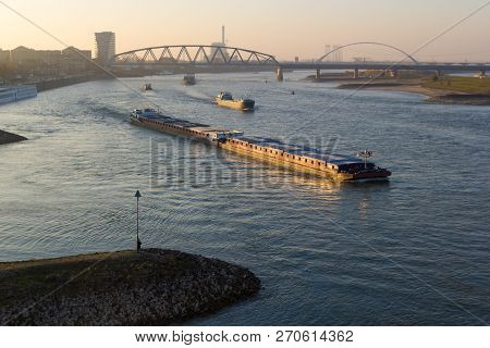 Nijmegen, The Netherlands - November 16 2018: Cargo River Barges Passing Near Nijmegen During Time O