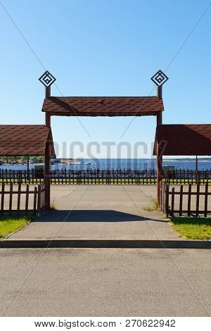 Wooden High Moles In The Chuvash National Style On A Summer Day On The River Bank