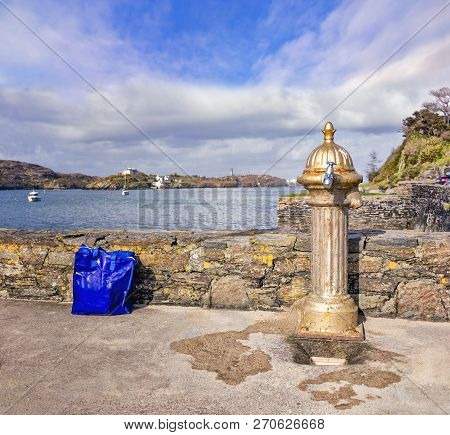 Old Water Column With A Shiny Tap In Crookhaven. Ireland.