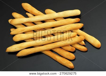 Traditional Italian Bread, Crispy Breadsticks Grissini On A Dark Wooden Table. Italian Grissini Clos