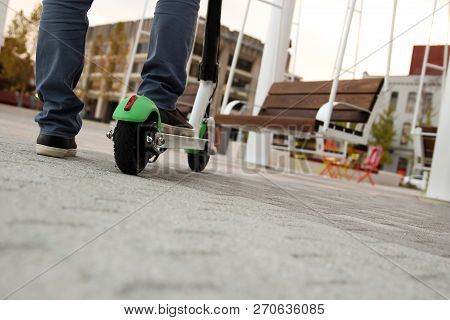 Close Up Image Of A Man On An Electric Scooter.